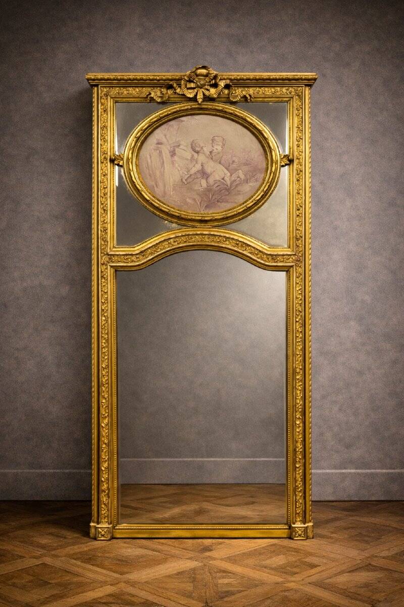 Very large mirror with mouldings, richly carved and gilded, in the Louis XVI style.