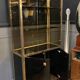 Hollywood Regency style bookcase shelf, gilded brass and black lacquered wood, 1970