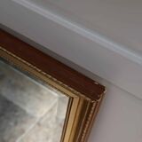 Large beveled mirror in carved wood