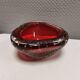 Small glass bowl in beautiful emerald red color with inlaid bubbles.