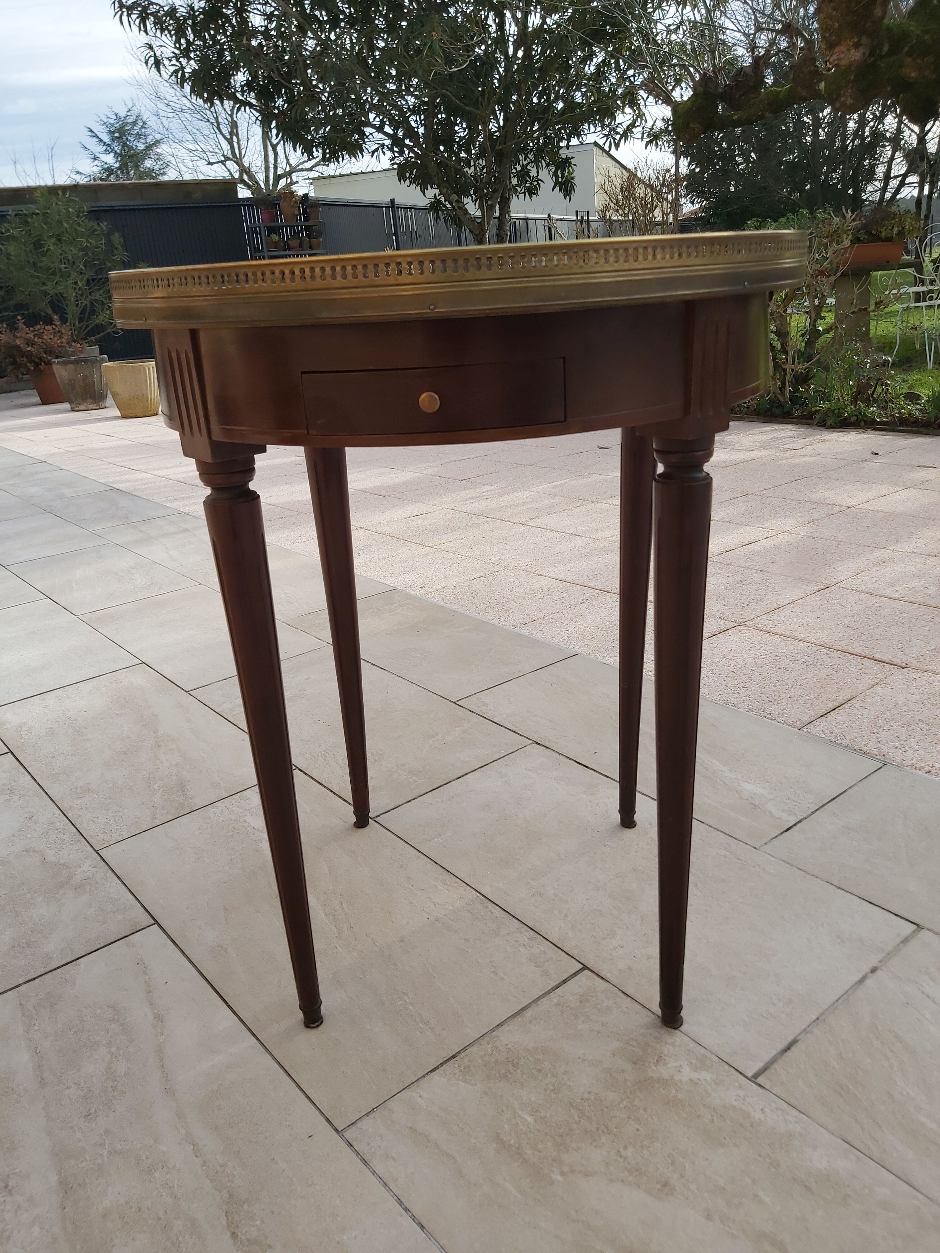 Gray marble mahogany pedestal table and brass gallery