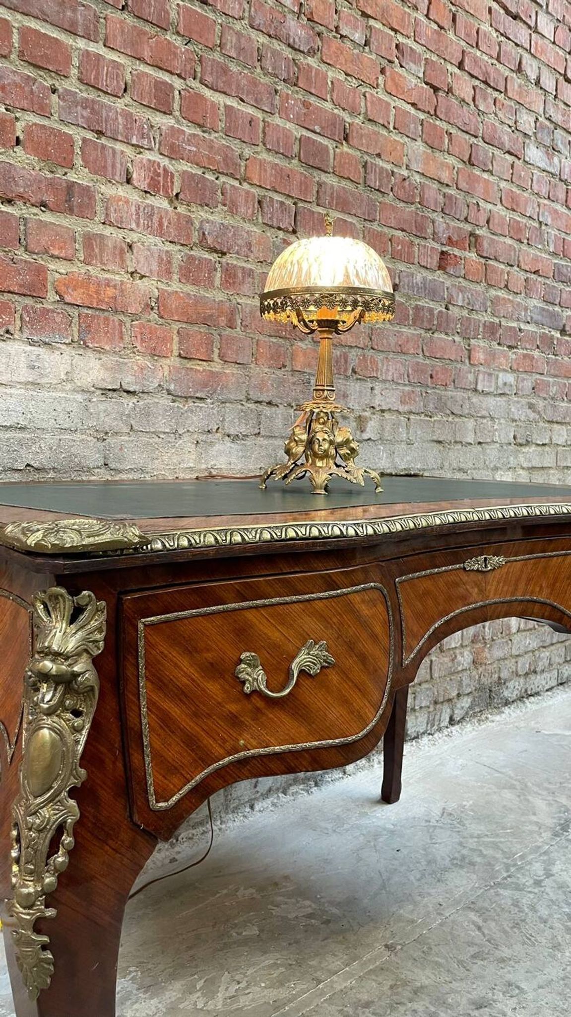 Antique French-style desk with green leather top and bronze mounts