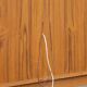 Elegant vintage Danish display cabinet with glass panels and atmospheric lighting