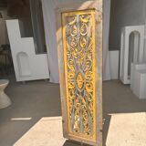 Rectangular Indonesian construction element with blue and yellow plant in carved wood