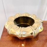 Golden brass ashtray with bamboo decoration.