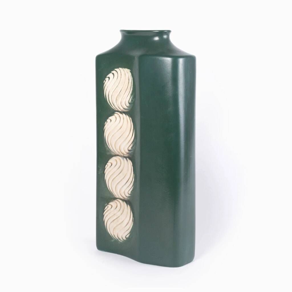 A tall ceramic vase glazed with dark green colour