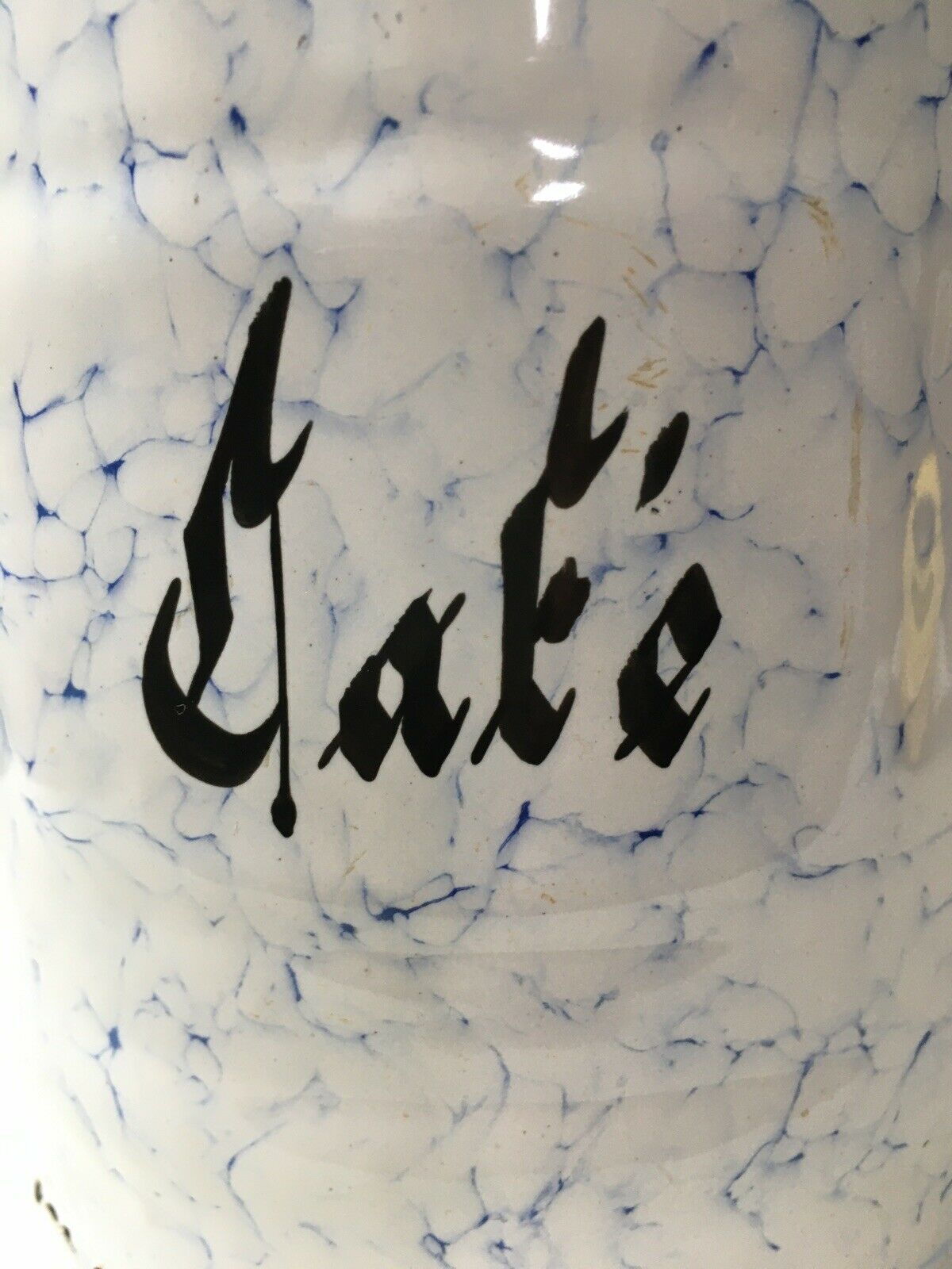 Vintage coffee pot in white enamelled iron and blue retro kitchen decoration
