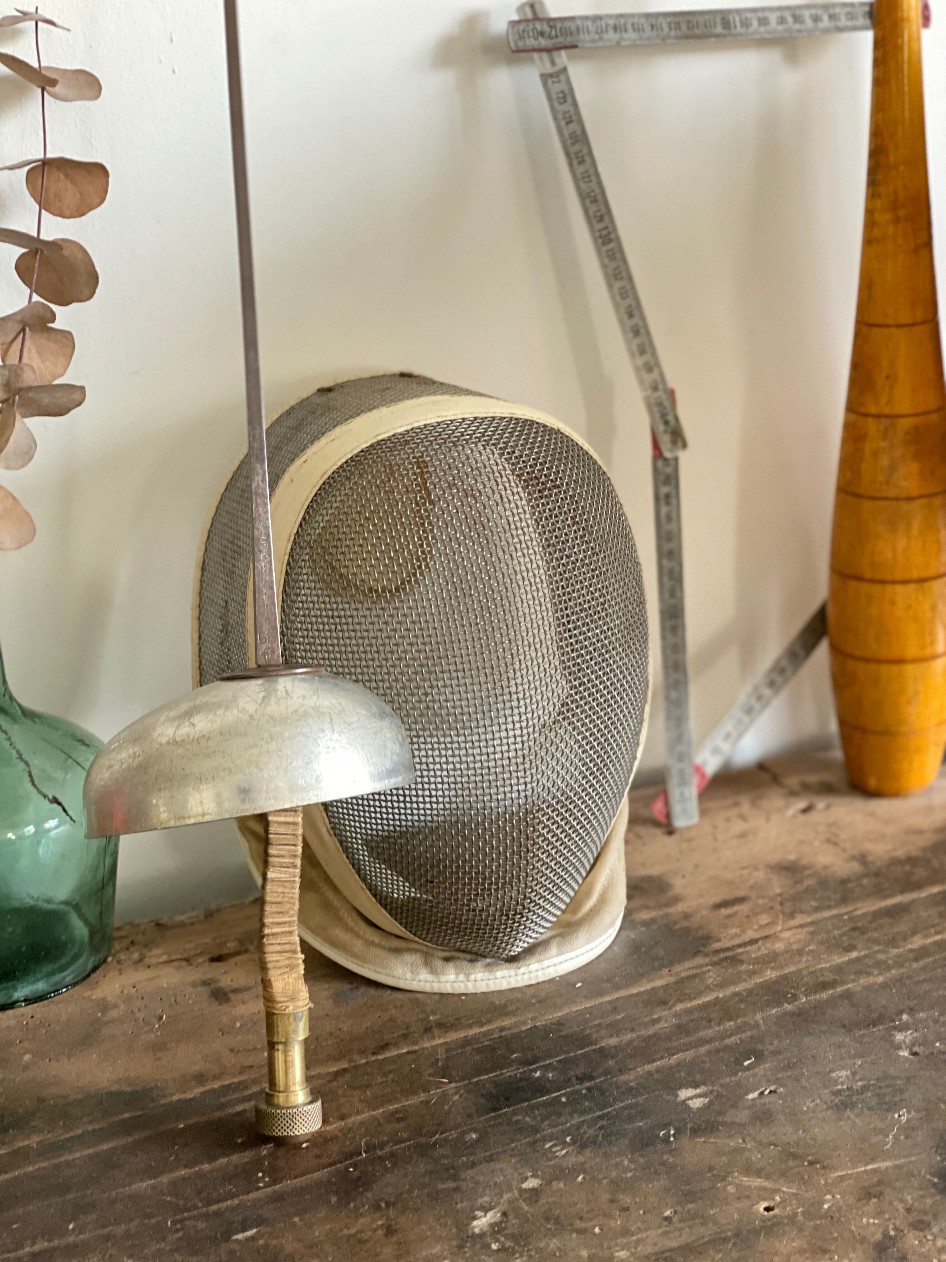 Old fencing mask set and its foil