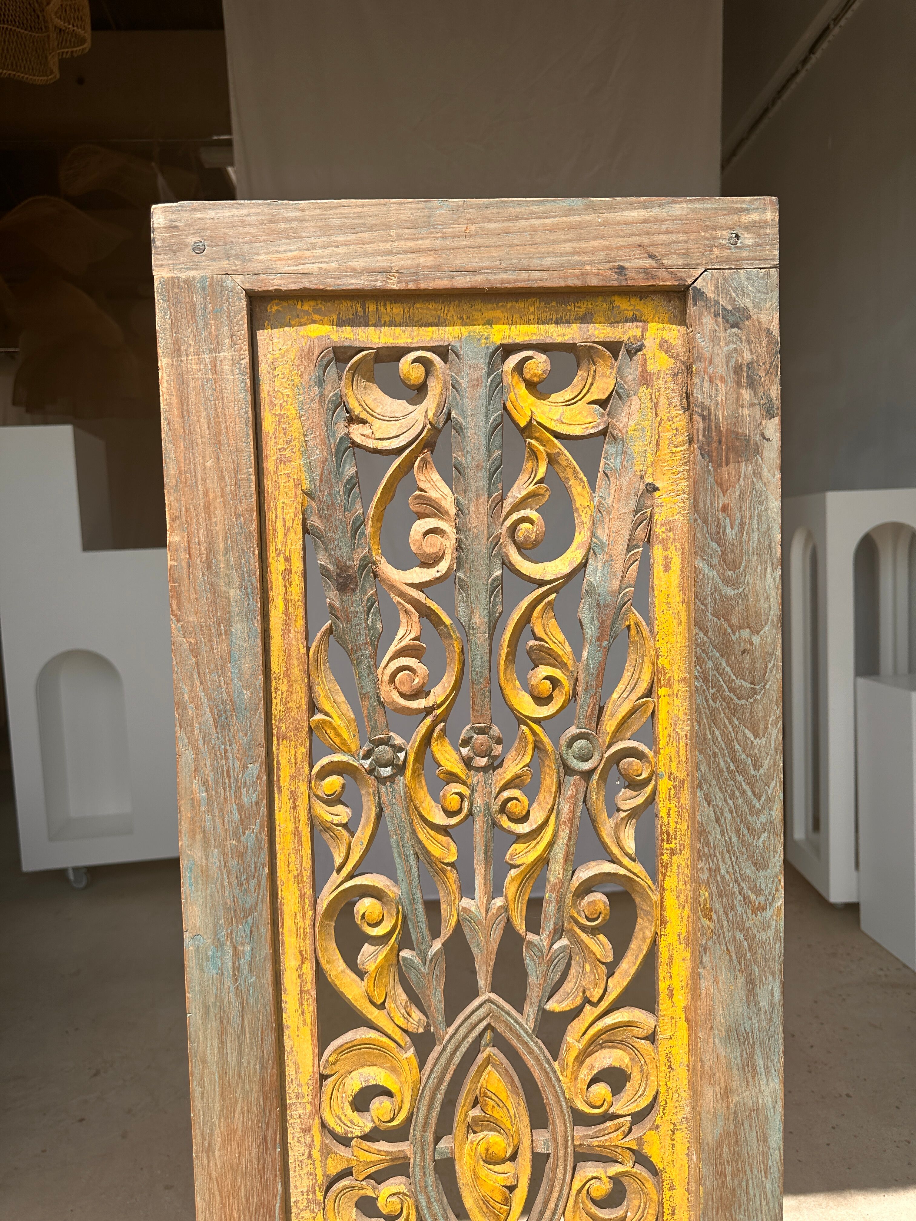 Rectangular Indonesian construction element with blue and yellow plant in carved wood