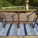 Richly carved solid wood bench in Louis XVI style.