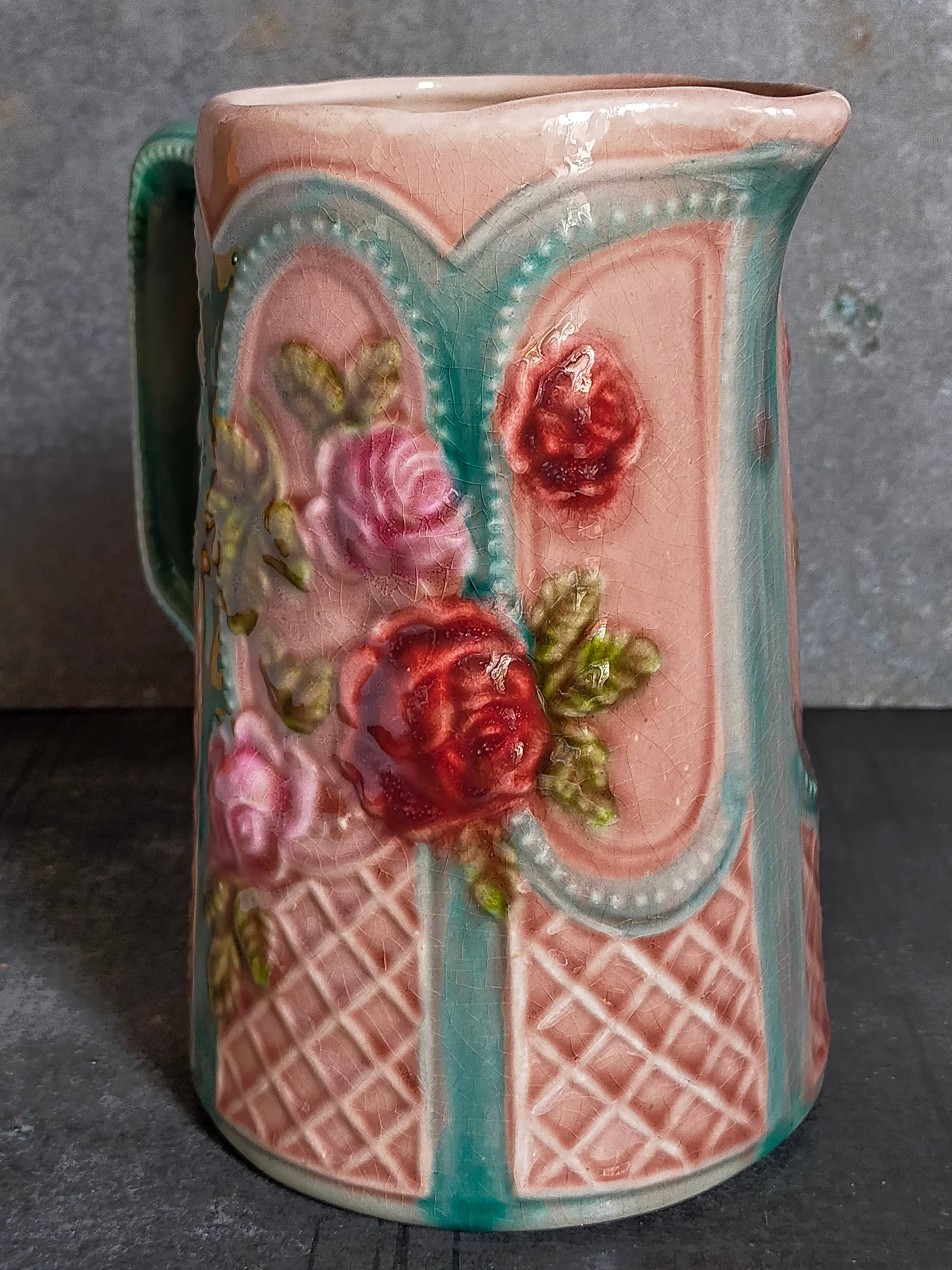 Antique slip pitcher with blooming roses