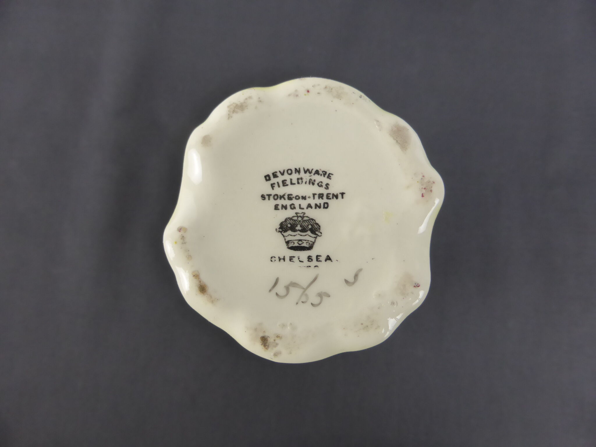 Old yellow ceramic vase decorated with flowers and a pheasant