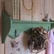 Antique wall shelf with a green patina