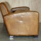Three-seater Art Deco style leather sofa with feather cushions.