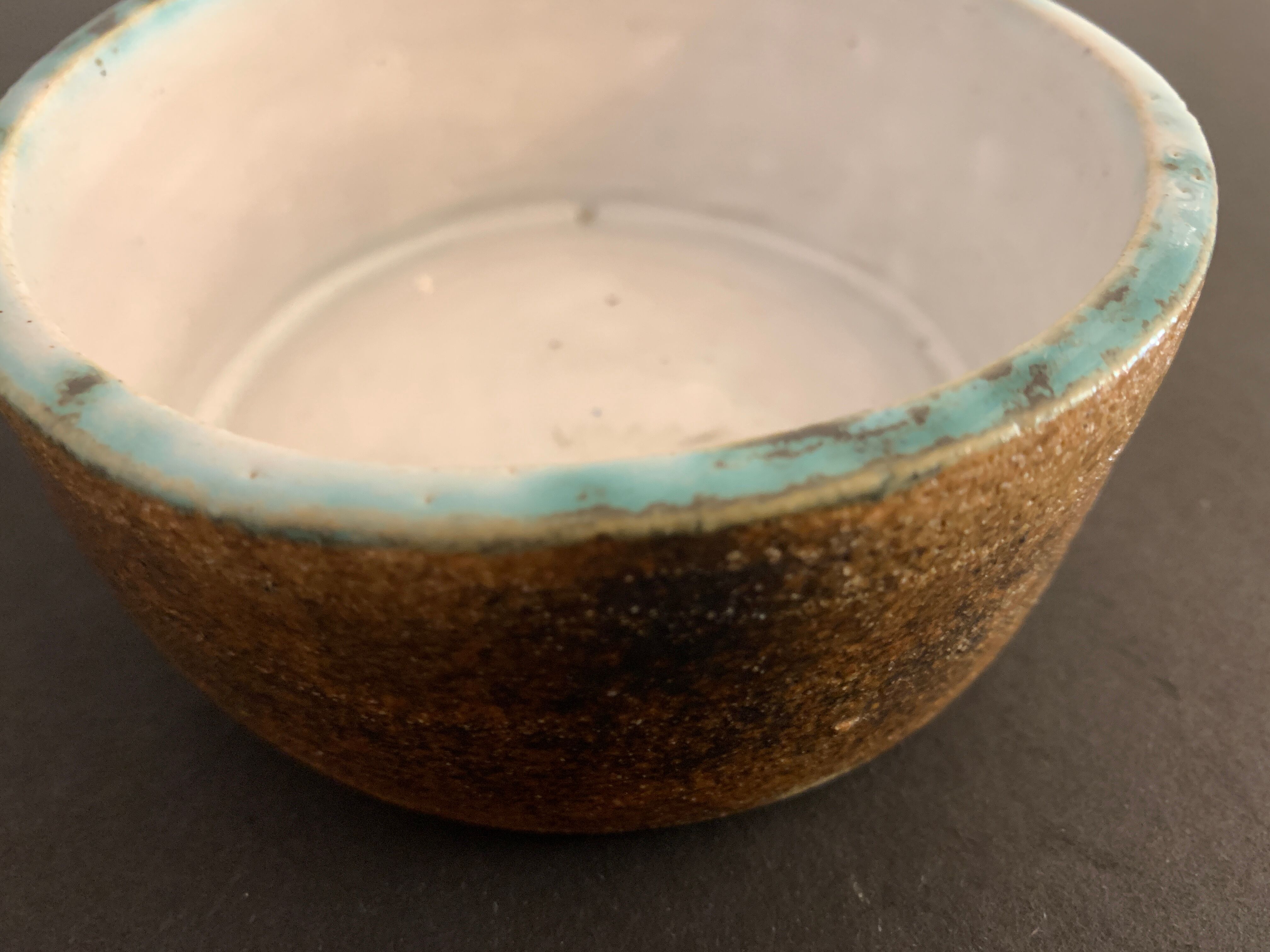 Round ashtray signed in sandstone with glazed interior
