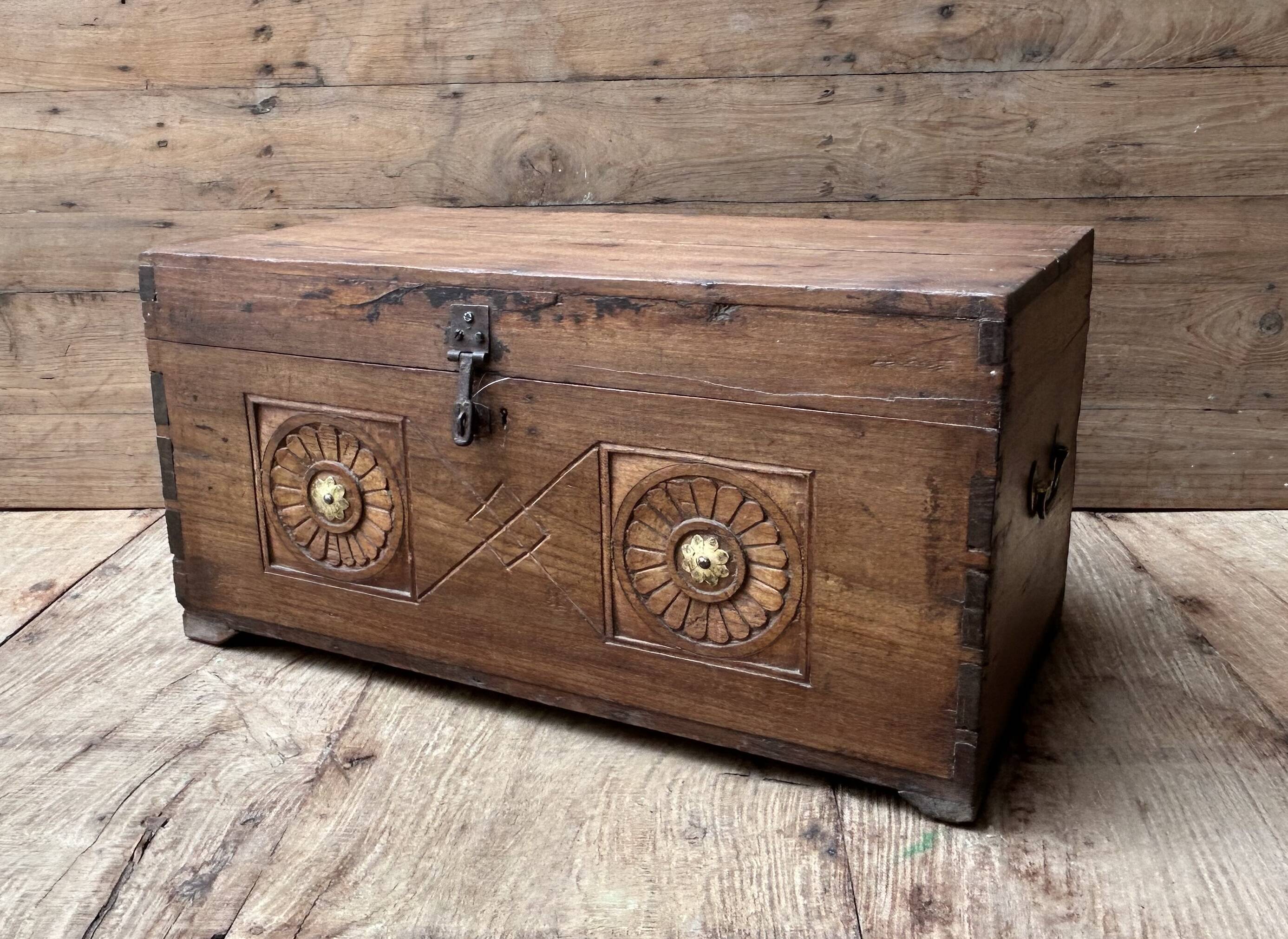 Teak chest from Burma with carved rosettes.