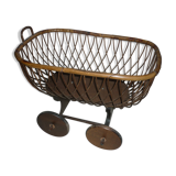 Cradle of doll in rattan on wheels