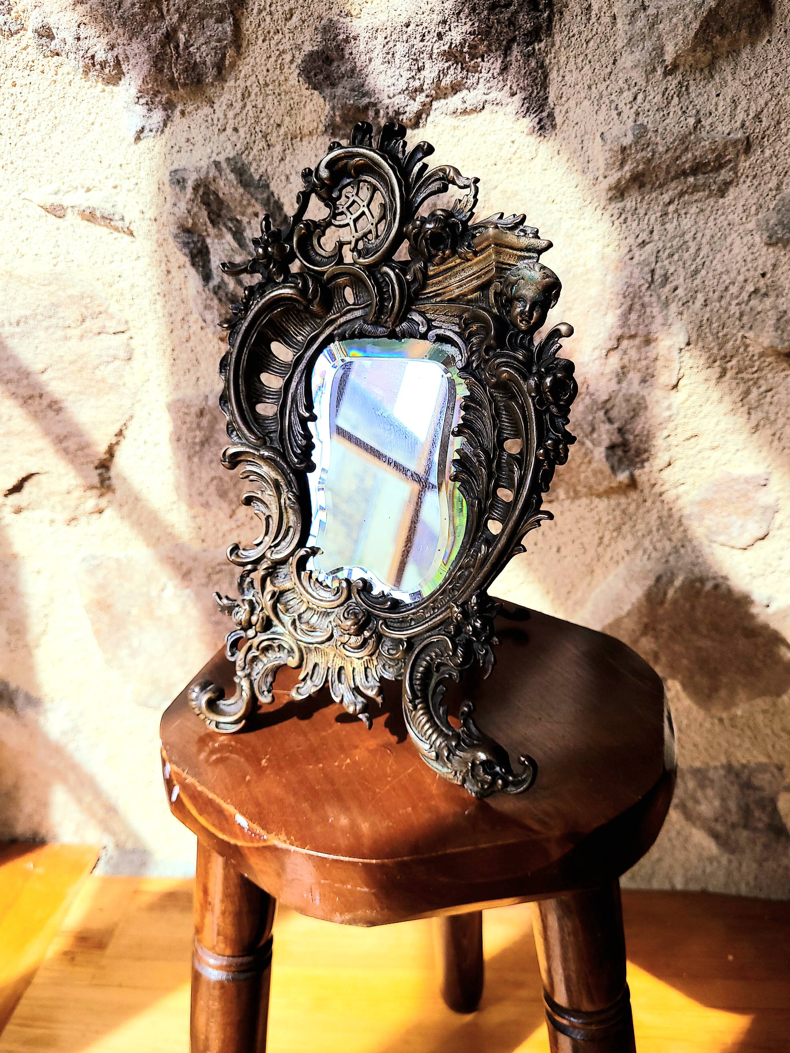 Antique bevelled bronze table mirror on stand, late 19th century.