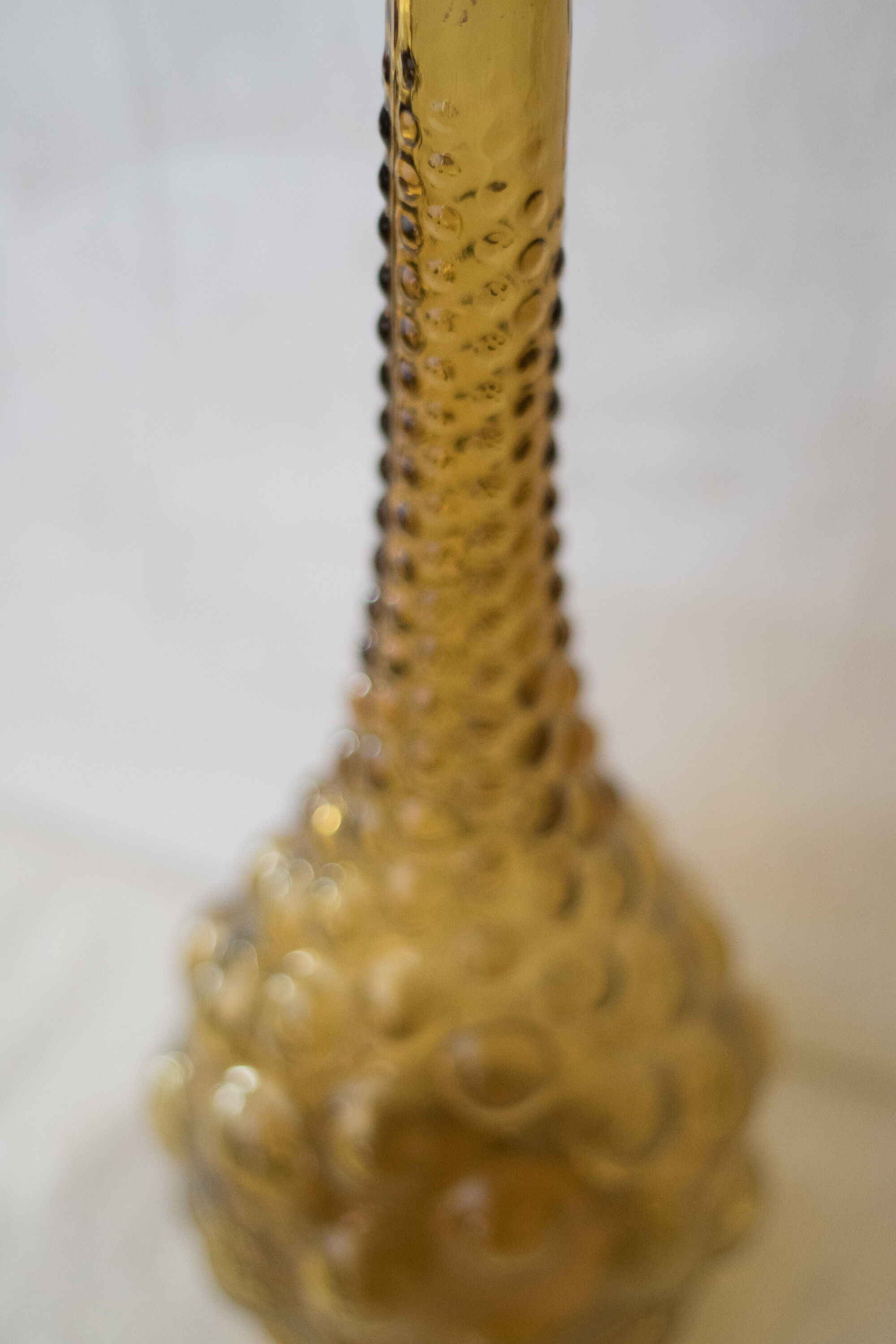 Green yellow bubble glass bottle