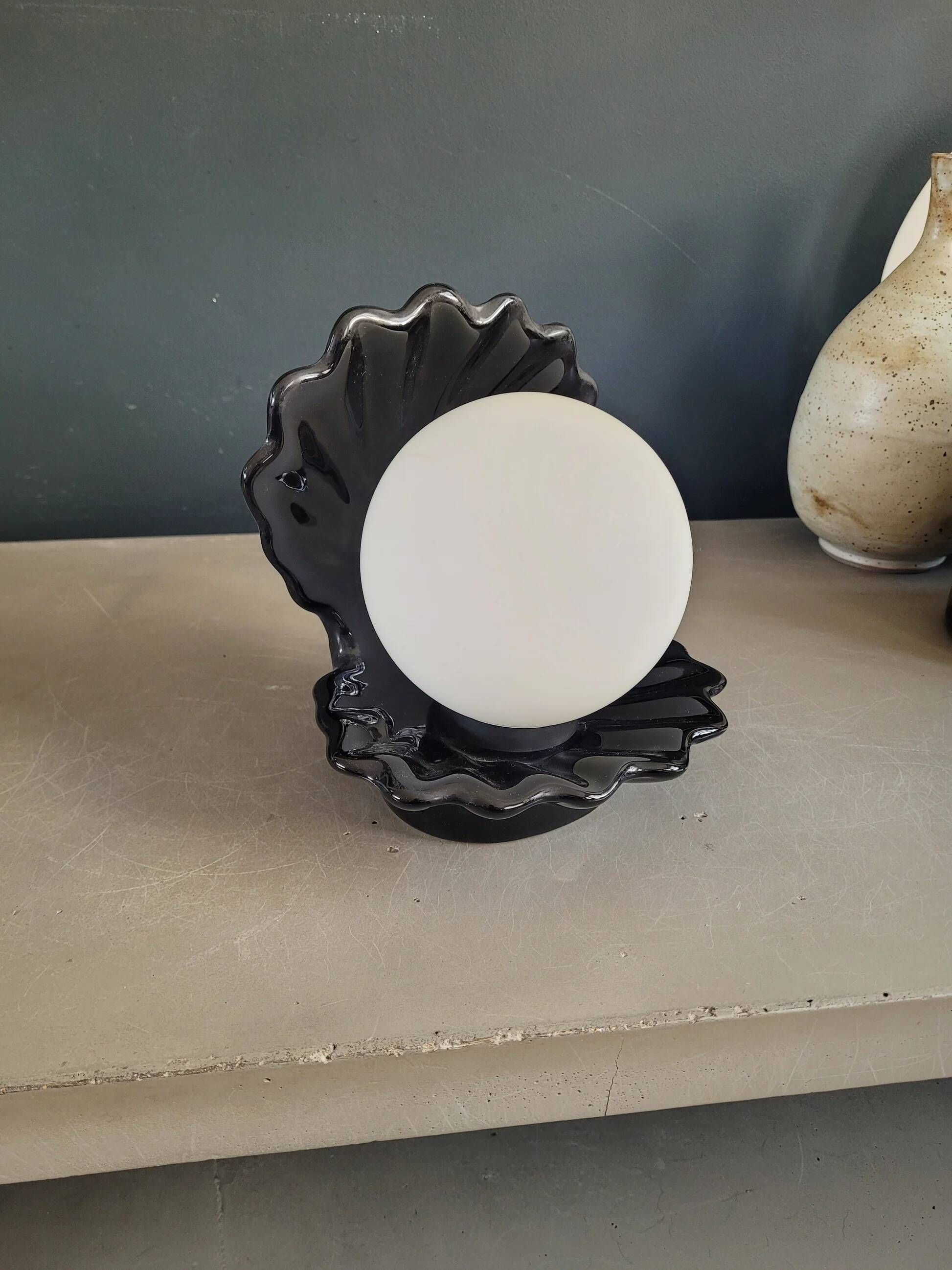 Vintage shell lamp in black porcelain with opaline globe.