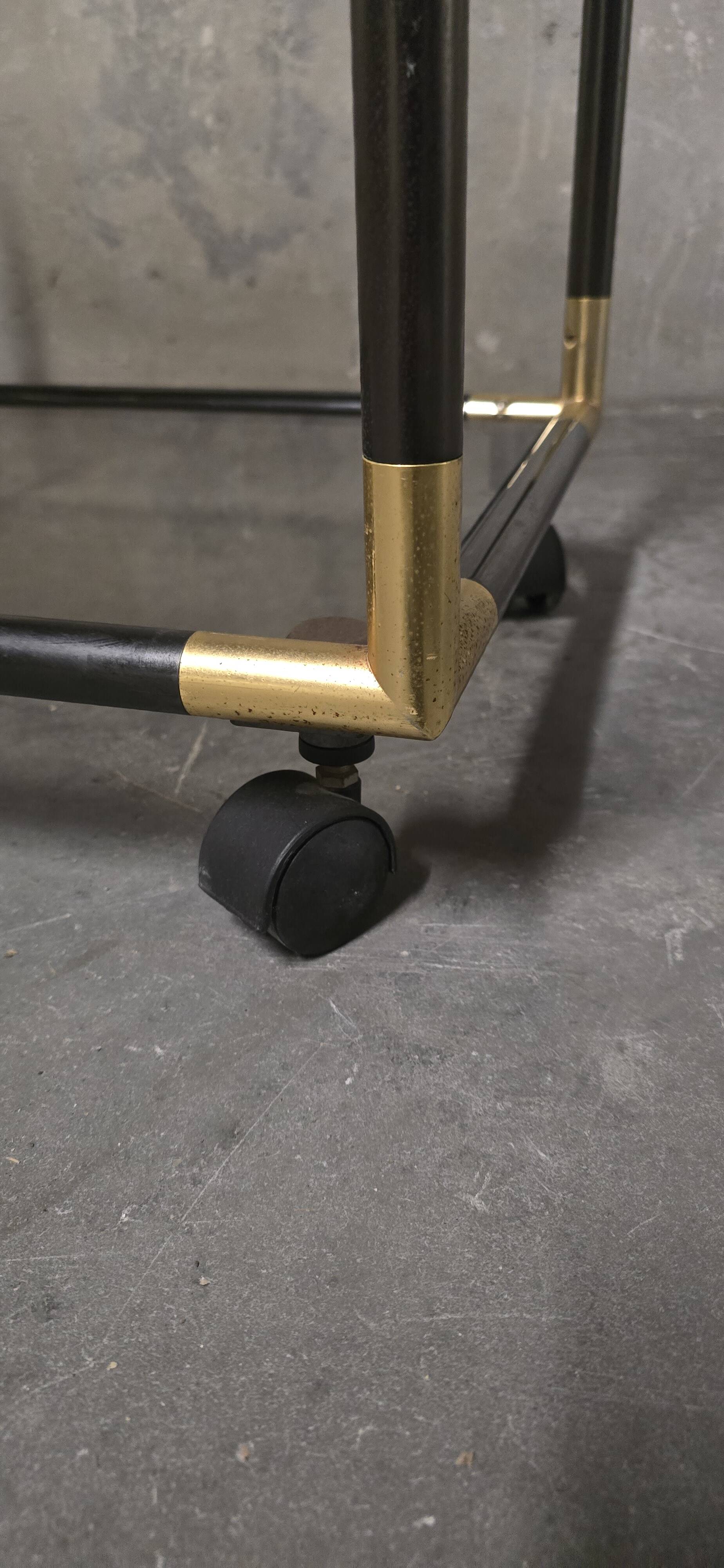Black metal and brass rolling dessert trolley, smoked glass, 1970s.