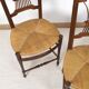 3 wooden and straw chairs, decorated with a sheaf of wheat.