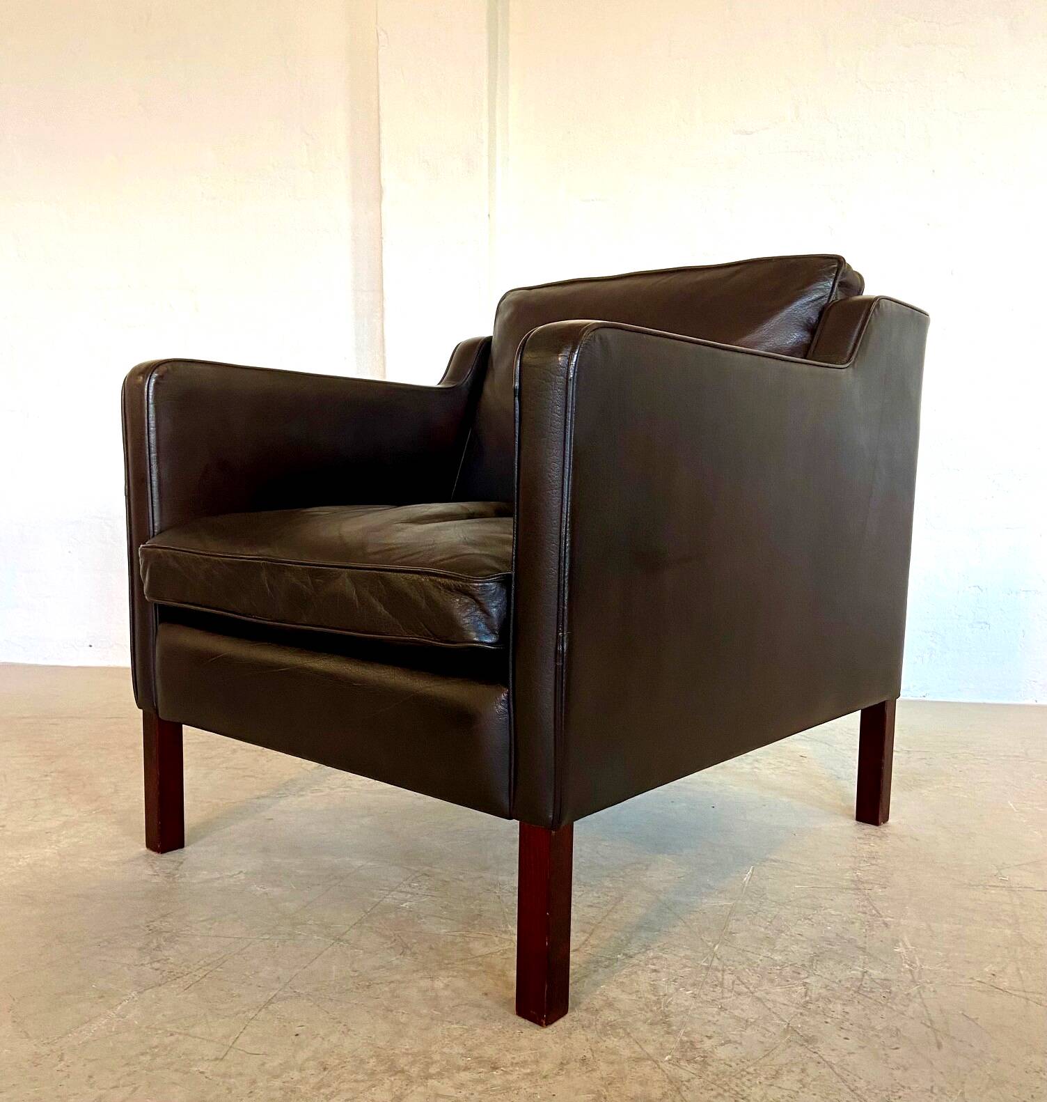 Mid-century Stouby leather lounge chair and stool in brown leather