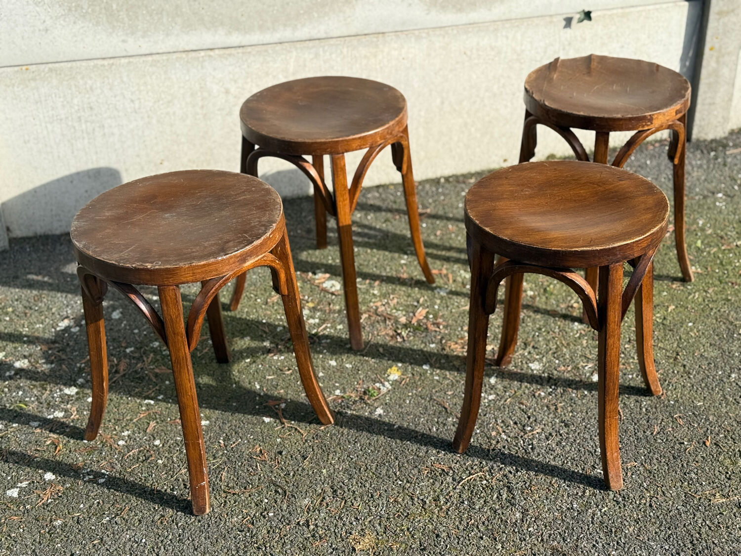 Set of four curved wooden stools stamped Baumann model 92.