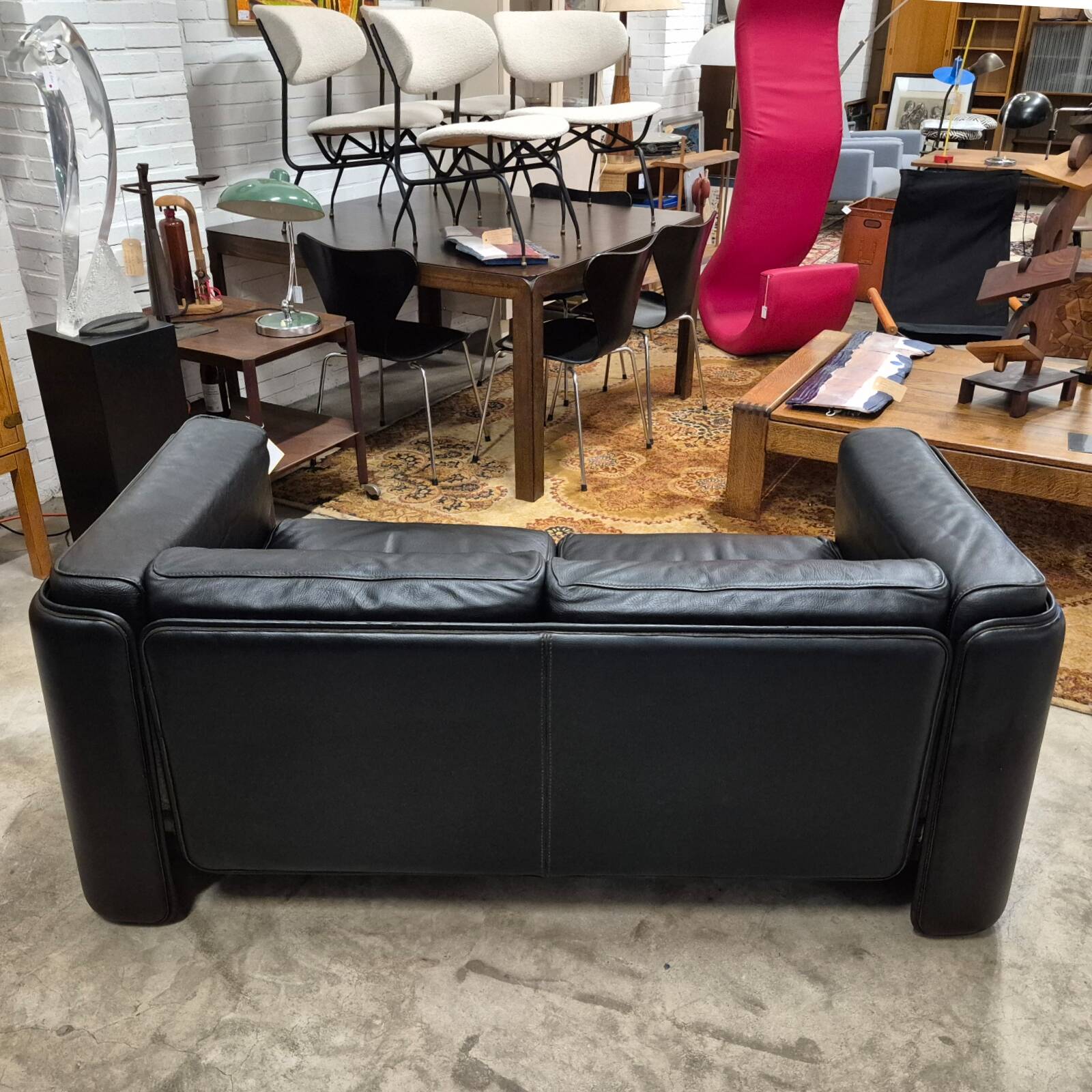 Two-seater sofa in black leather, designed by Tito Agnoli for Poltrona Frau, Italy, 1980s