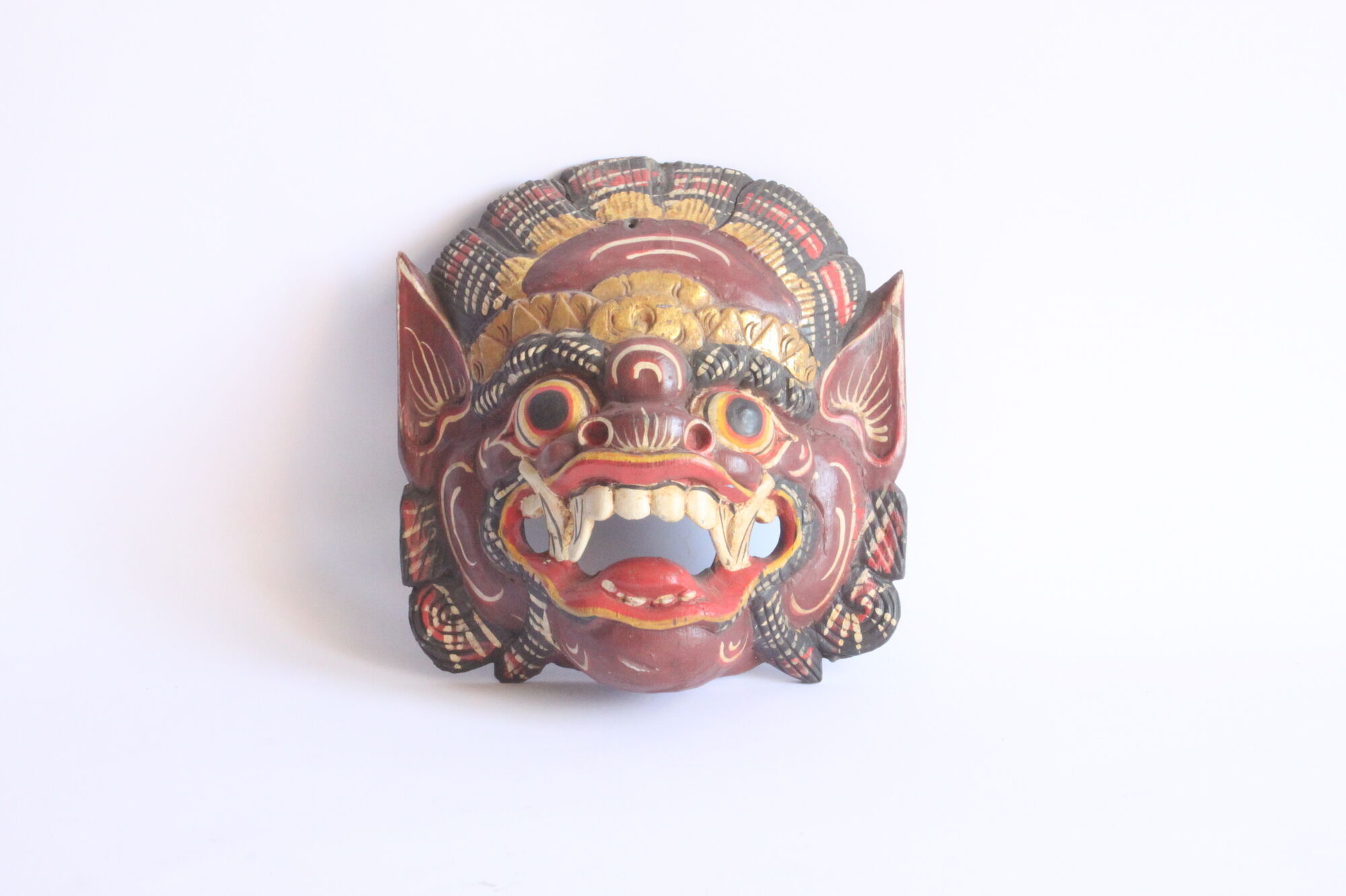 Two polychrome painted and gold leaf gilded Barong dance masks from Bali, Indonesia.