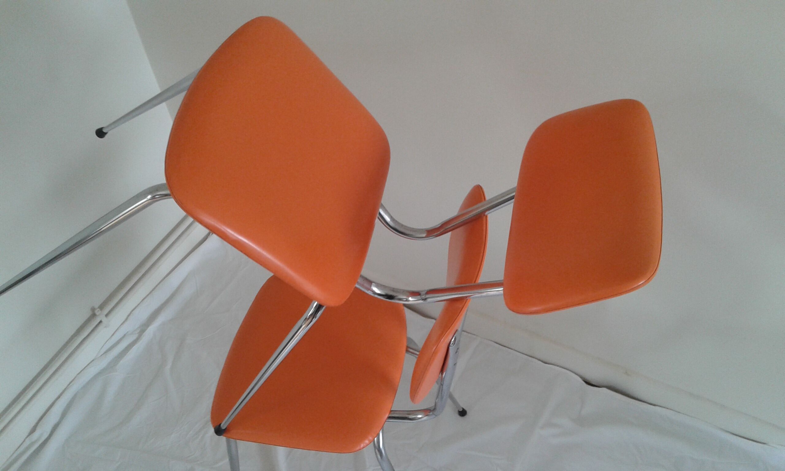 Duo of vintage chairs in orange skai