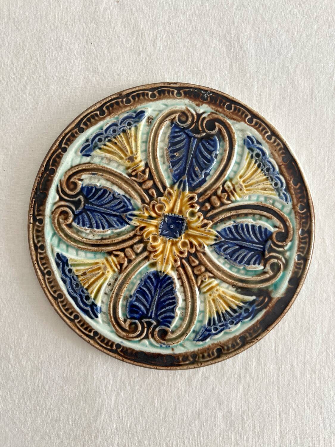 Art Nouveau earthenware bottle coaster/trivet, late 19th/early 20th century