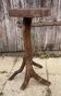 "Root" gueridon in solid wood — organic silhouette, brutalist spirit.