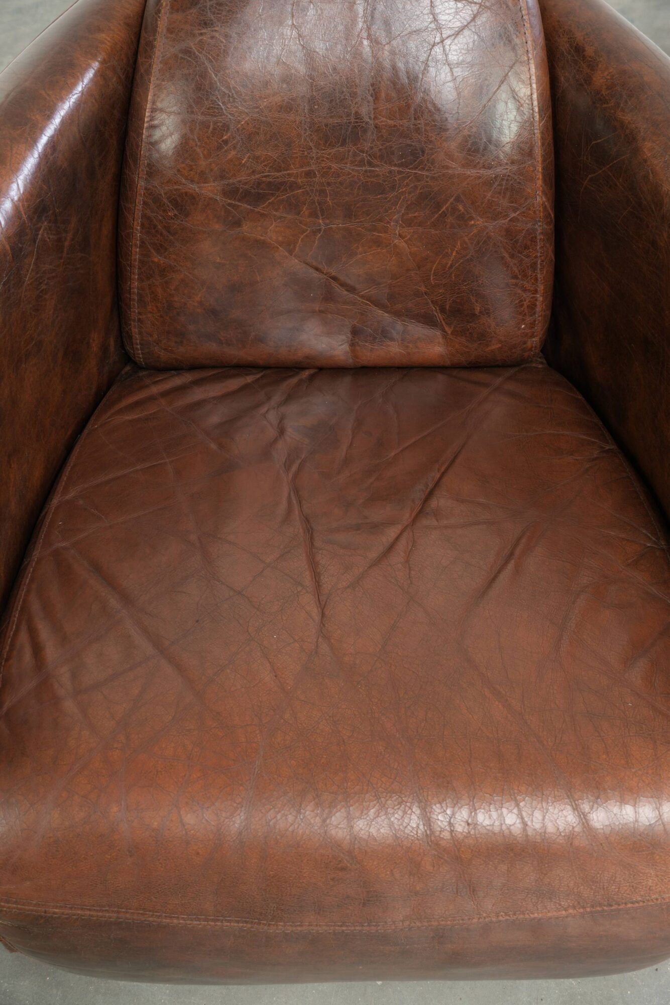 Cowhide armchair in Aviator design in a warm brown colour
