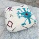 Berber floor pouf: Handwoven Moroccan wool cushion.