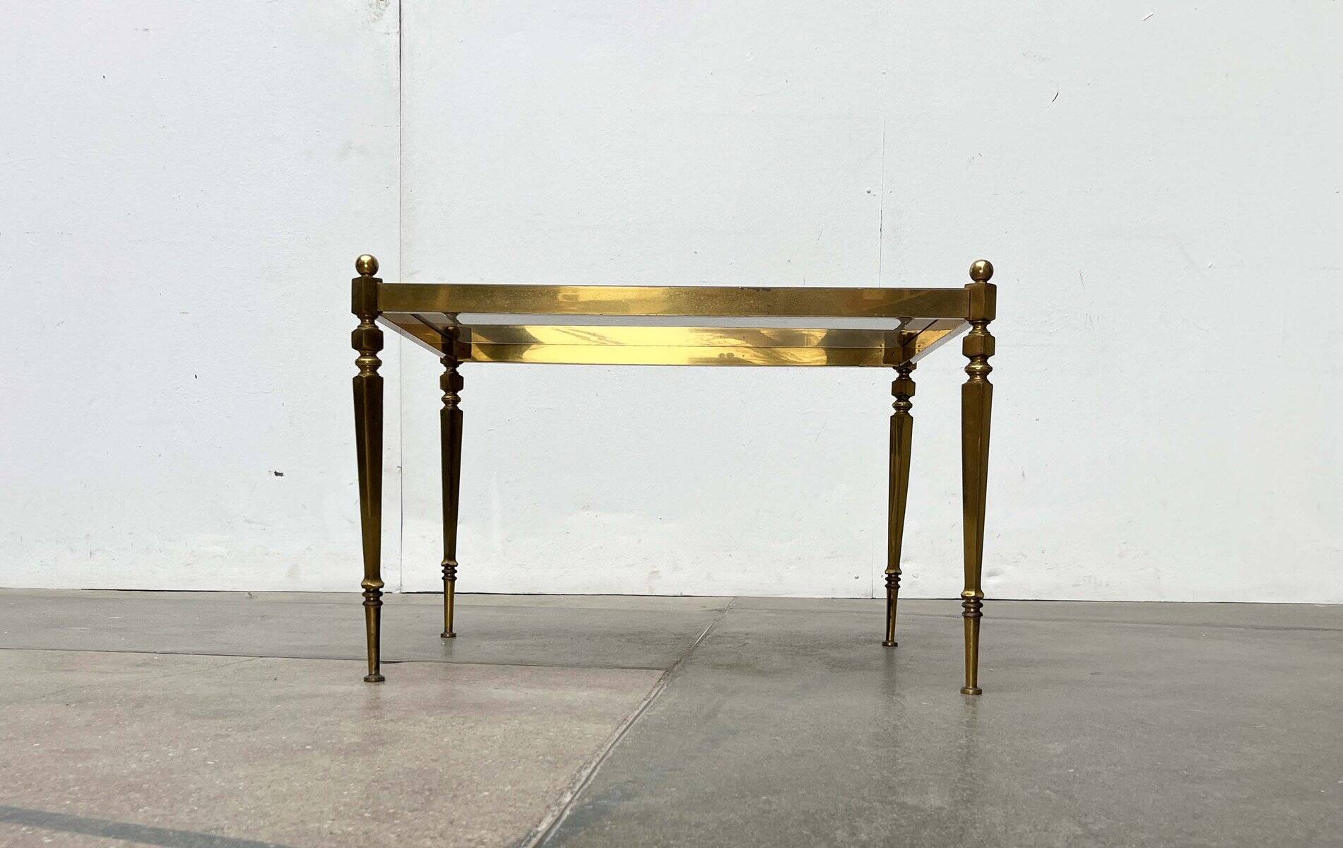 Mid-century German Hollywood neoclassical brass and glass side table from the 1950s.