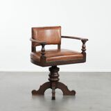 Elegant antique sheepskin leather desk chair with a heavy wooden frame