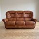 Living room set: 3-seater sofa and 2 brown leather armchairs.