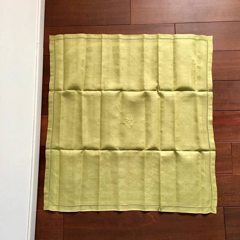 Old embroidered green square table napkin with cutwork