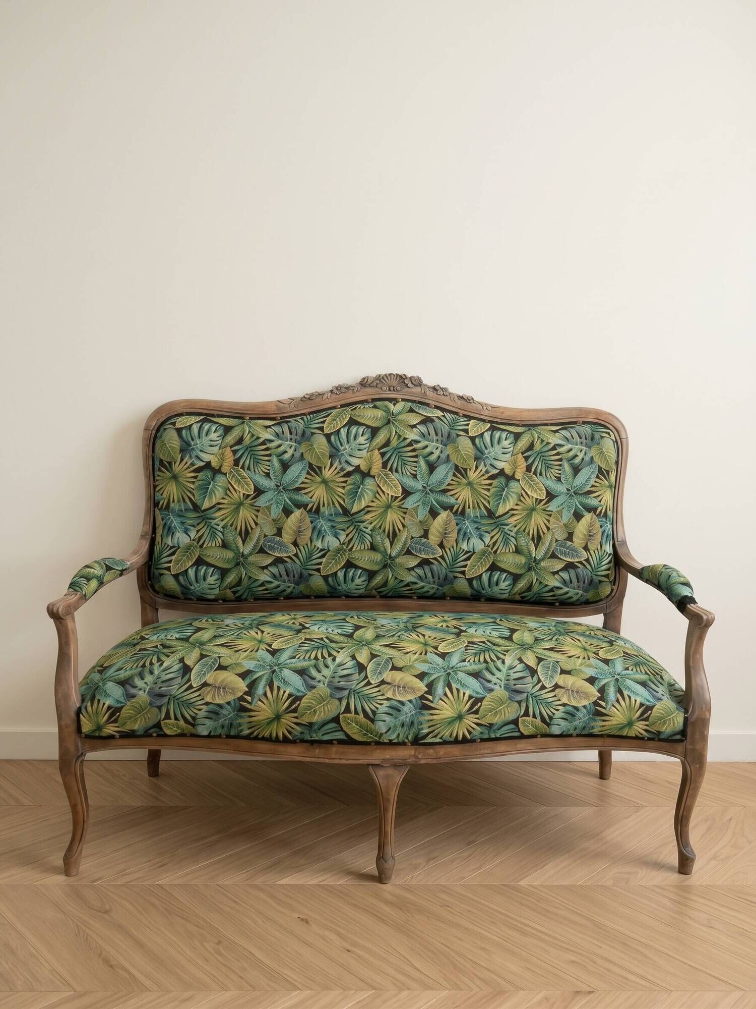 Louis XV bench reupholstered with a green tropical pattern.