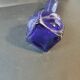 Vintage cobalt blue glass vase with foliage decoration.