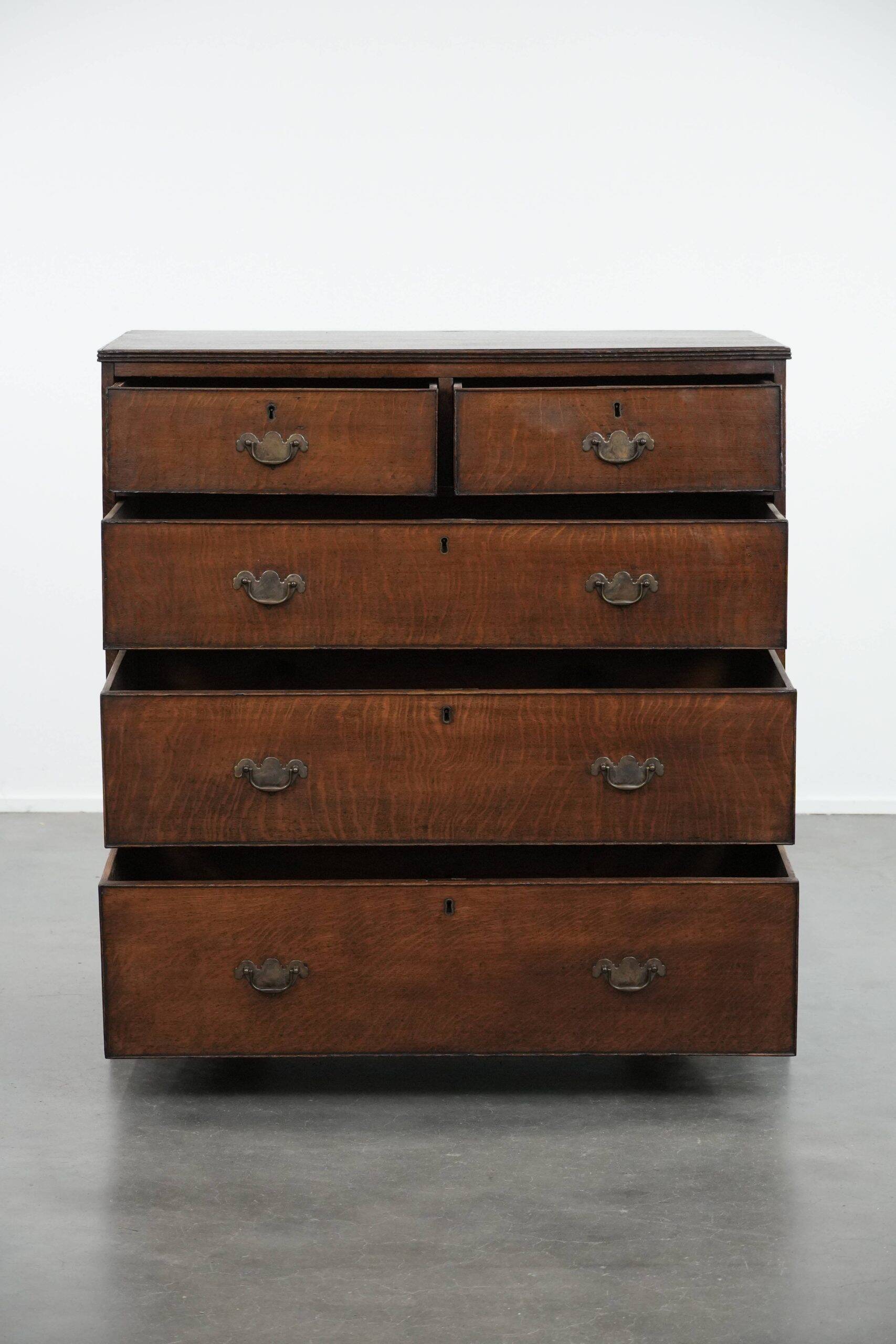 Antique English oak commode dating from the late 18th century.