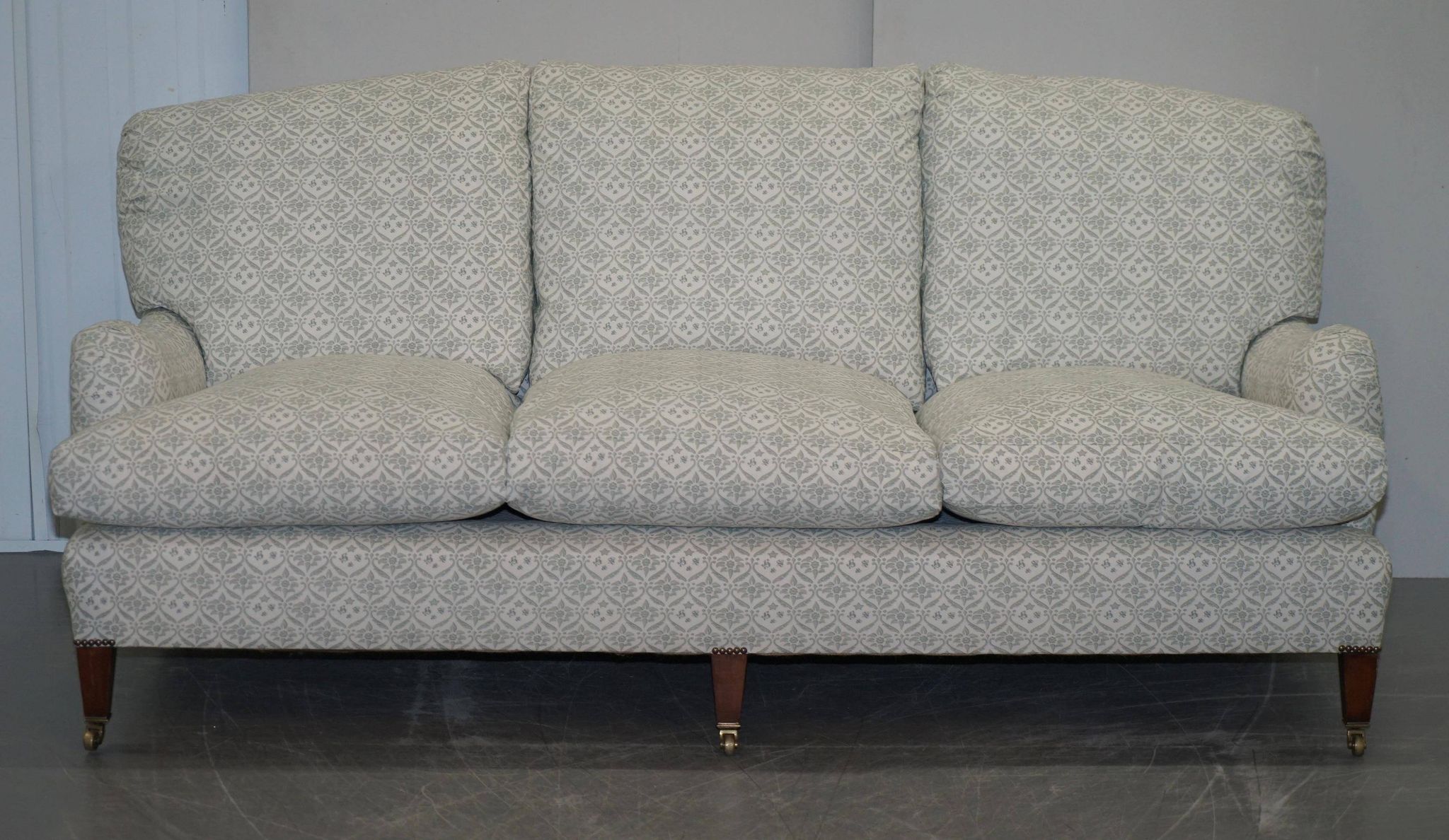 Howard & Sons canapé with feather cushions and ticking fabric, Victorian style.