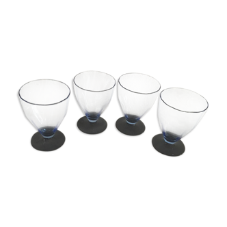 Four vintage glasses of water or wine with blue highlights