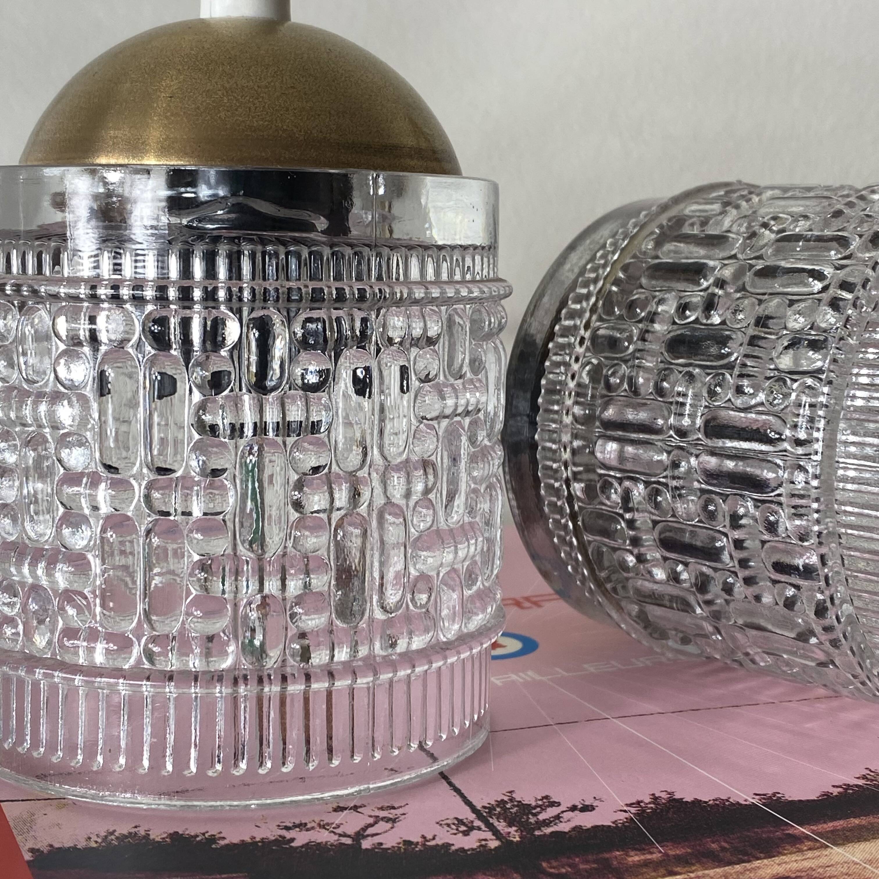 Pair of small portable tulip lamps in transparent glass.