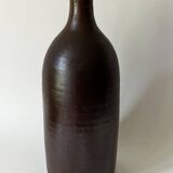 Old bottle in matte brown stoneware