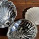 Vintage silver-plated shell butter dish with transparent bowl.