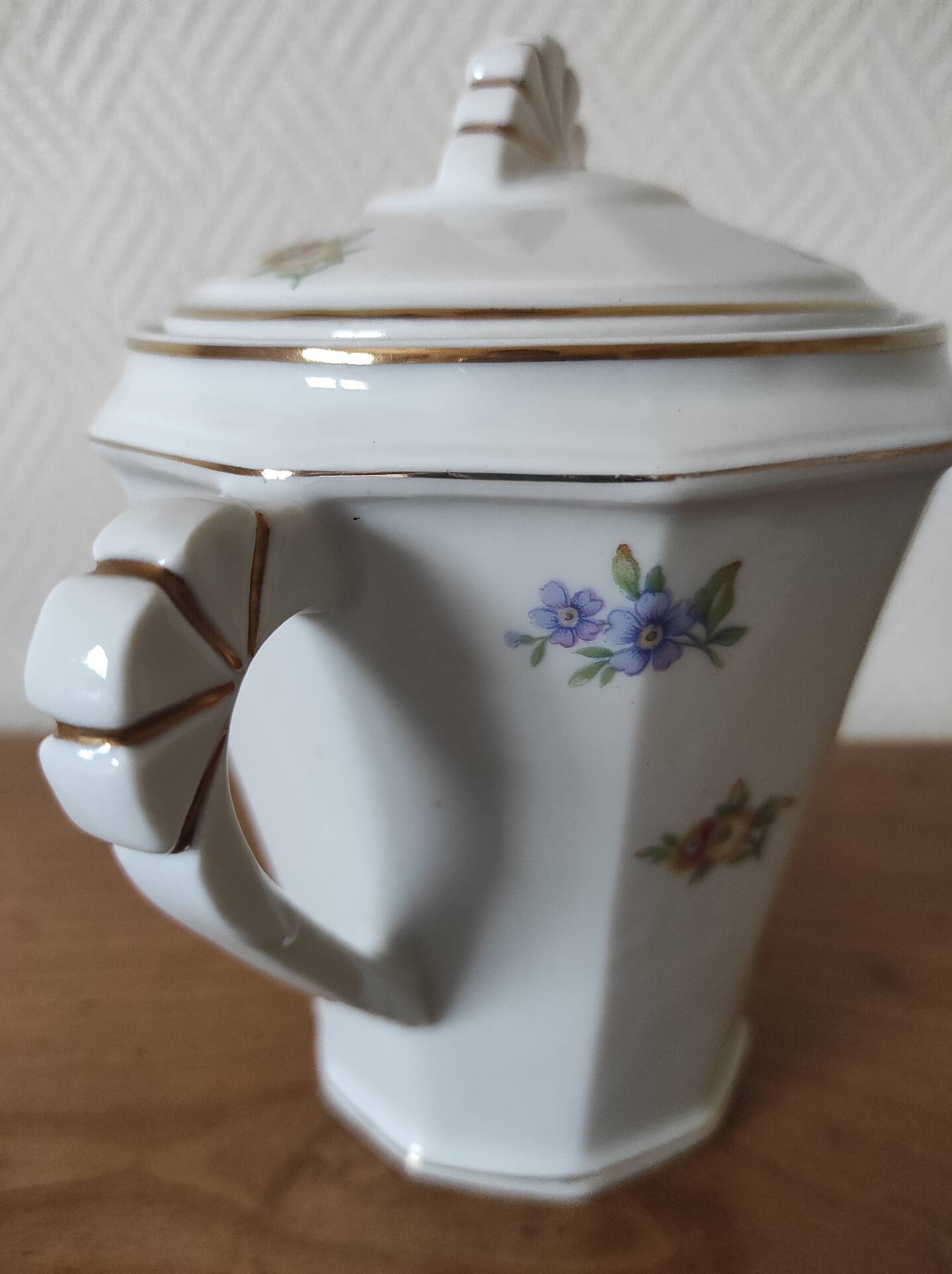 Antique porcelain sugar bowl with a decagonal base.