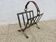 Magazine rack in raw steel and leather, in the style of Jacques Adnet.