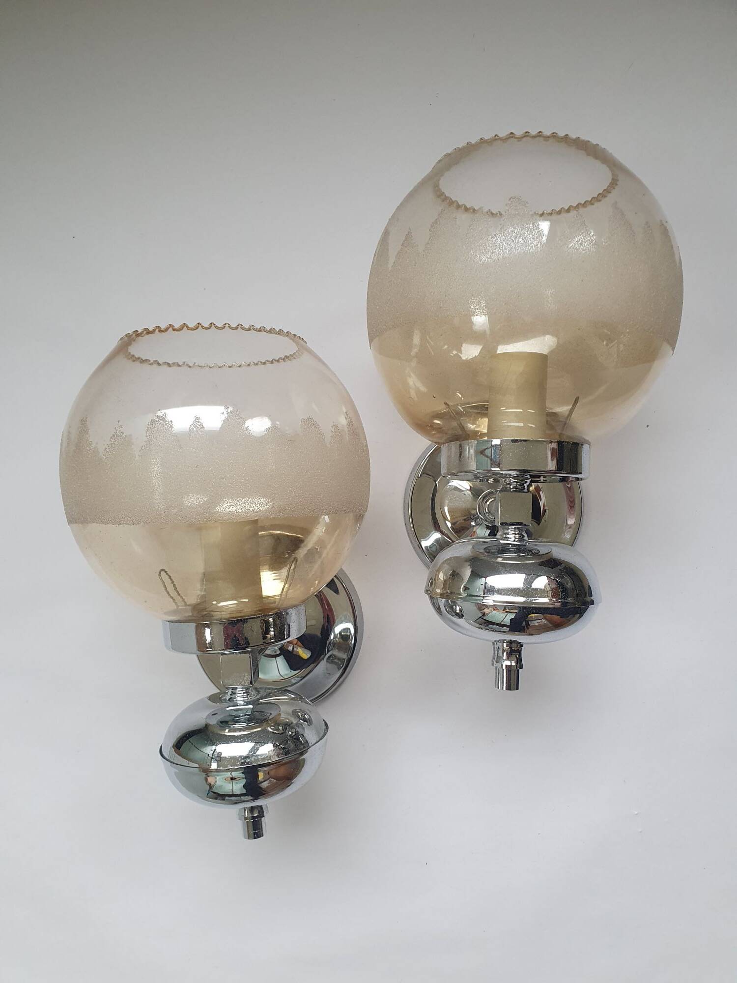 Pair of chrome metal wall lights with vintage sandblasted glass globes